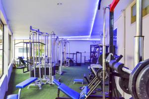 a gym with a bunch of equipment in it at Royal Brongto Hotel in Timuran