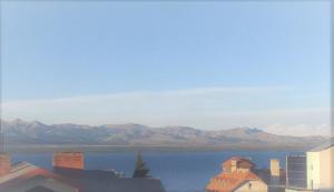 a view of a large body of water with mountains at Lofts Patagonia Mitre 3 in San Carlos de Bariloche