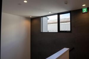 a room with black walls and a window at Second Home 瀬戸風月 in Takamatsu