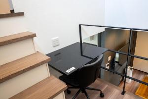 an office with a glass desk and a black chair at Second Home 瀬戸風月 in Takamatsu