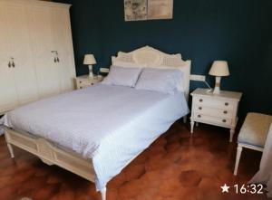 a bedroom with a white bed and two night stands at Spacious family flat centrally located. in Palamós