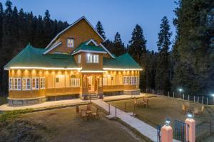 a large yellow house with a green roof at Gulmarg Ski Hill Resort in Gulmarg