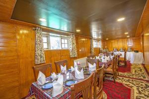 a dining room with tables and chairs in it at Gulmarg Ski Hill Resort in Gulmarg