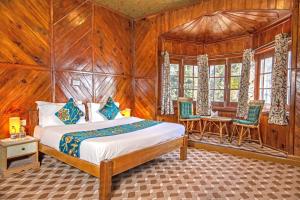 a bedroom with a bed in a room with wooden walls at Gulmarg Ski Hill Resort in Gulmarg