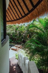 an outside view of a resort with a patio with palm trees at Barrels at Bingin in Uluwatu