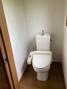 a bathroom with a white toilet in a room at Breath in Earth in Nagano