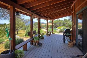 a porch of a wooden house with a wooden roof at Manzanita Ridge Estate by Bnb Yosemite in Mariposa