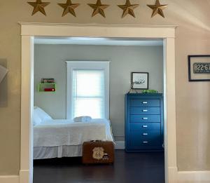 a bedroom with a bed and a dresser with stars on the wall at The Old Riverton Post B&B in Riverton