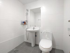 a white bathroom with a toilet and a sink at Jeju Hanibaram Pension in Jeju +28 photos