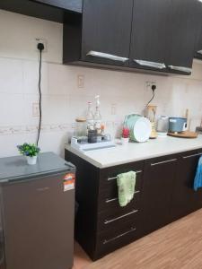 a kitchen with a sink and a stove top oven at Laguna laguni Homestay in Sungai Petani