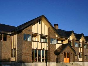 a large brick building with a black roof at Lake side inn Beehive in Kitashiobara