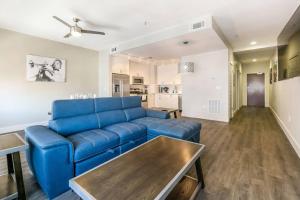 a living room with a blue couch and a table at Spacious Modern Condo near French Quarter in New Orleans