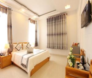 - une chambre avec un lit et un ordinateur portable dans l'établissement Yen Nam Hotel Nguyen Trong Tuyen, à Hô-Chi-Minh-Ville