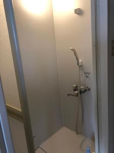 a shower stall in a bathroom with a shower at Corpo Marika A in Hakodate