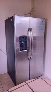 a stainless steel refrigerator with a dispenser on the door at Alpha Arenal in Fortuna