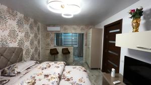 a small bedroom with a bed and a fireplace at La Carmen 2 ! Apartament 1 camera! in Lupeni
