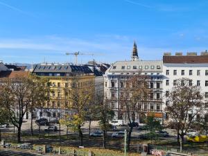 a view of a city with buildings and trees at Open View City Apartment in Vienna