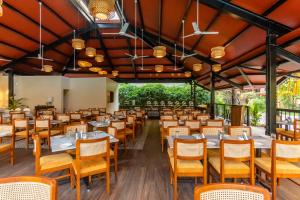 a dining room with tables and chairs at Somy Plaza Calangute Goa - Formerly Somy Resort in Calangute