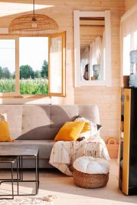 a living room with a couch and a table at Mereäärne helesinine suvemaja in Tahkuranna