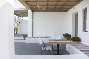 a patio with a table and chairs on a house at Superior Villa Lino in Skiros