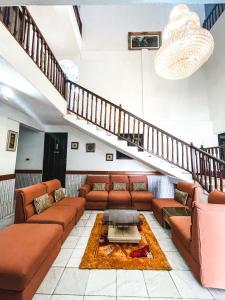 a living room with a couch and a table at Hill View Hotel McCarthy Hills in Bortianor