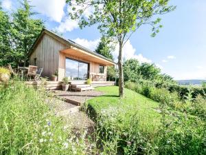 a small house on a hill with a garden at Yartleton Farm in Aston Ingham