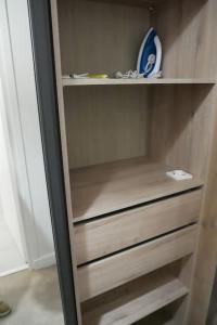 a wooden cabinet with drawers in a room at Joli studio proche des thermes in Aix-les-Bains