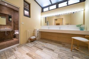 a bathroom with a large sink and a large mirror at 歐堤斯旅店 Otis Inn-花蓮民宿2531-2541-2555-2556號 in Hualien City +75 photos
