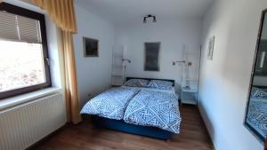 a bedroom with a bed and a window at Apartments Kapus Center in Bled
