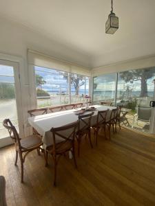 a large dining room with a long table and chairs at The Ultimate Beach House in Kingston Beach