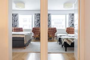 a room with two beds and a mirror at City Garden Apartments 2 in Rovaniemi