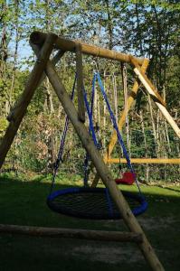 a playground with a swing in a park at Le Walkoti - cosy cottage with 2 bedrooms in Waimes