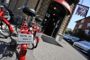 a bike parked on a sidewalk in front of a building at Hotel Ziò Imola in Imola