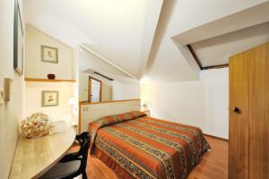 A bed or beds in a room at Hotel Ziò Imola