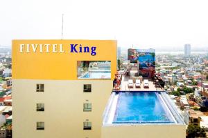 a hotel with a swimming pool on top of a building at FIVITEL King in Danang
