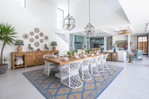 a dining room with a long table and chairs at Umbala the house in Canggu