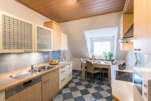 a kitchen with a sink and a table at Weinbau Frank Schönig in Sommerhausen
