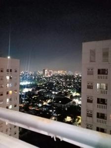 vista de uma cidade à noite com edifícios em Comfort 2BR green pramuka bougenvile em Jakarta