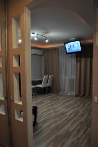 a conference room with a table and a television on the ceiling at Dwell Apartments in Kremenchuk