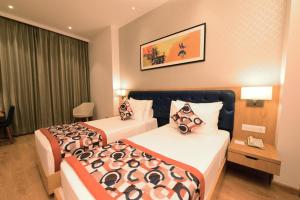a hotel room with two beds and a telephone at SureStay by Best Western Model Town in Amritsar