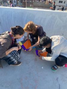 a group of people playing with a kite at Chalo Eco Hostel in Jaipur