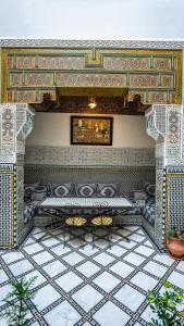 a room with a bed and a tiled floor at Riad Green House in Fès
