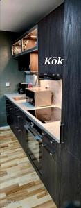 a kitchen with a kok sign on the wall at ÖSTERLEN PARKEN in Simrishamn +6 photos