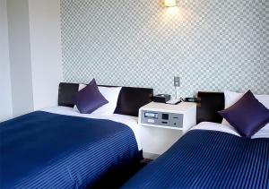 Postel nebo postele na pokoji v ubytování Hotel Livemax BUDGET Kanazawa-Idaimae