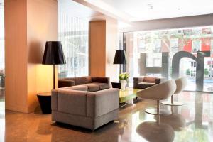 a lobby with a couch and chairs and a table at NH Madrid Principe de Vergara in Madrid