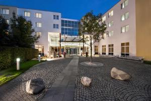 a building with rocks in front of a building at NH Frankfurt Airport West in Raunheim