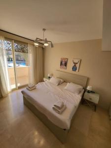 a bedroom with a large bed with two towels on it at Mangroovy Ritzy, Cerulean appartement by the pool in Hurghada