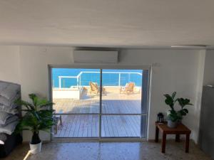 a living room with a view of the ocean at Seawave Panthouse in Netanya