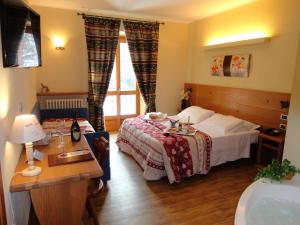 a hotel room with a bed and a window at Grand Hotel Principe in Limone Piemonte