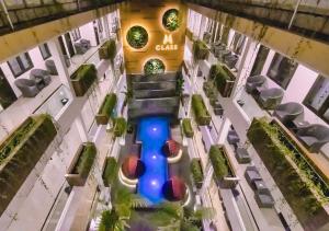 an overhead view of a building with a swimming pool at Class Premium Guest House in Kasri